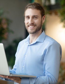 young-smiling-man-with-a-laptop-in-his-hands-2021-09-04-07-08-07-utc