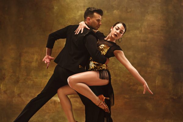 dance-ballroom-couple-in-gold-dress-dancing-on-studio