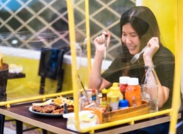 asian-woman-sitting-self-isolate-in-steak-restaura-LSDD4SV