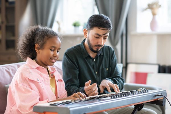 adorable-schoolgirl-and-her-music-teacher-playing-2021-12-16-00-26-04-utc