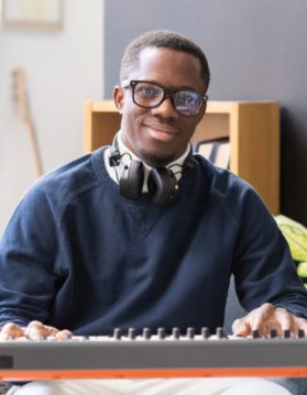 happy-young-man-in-eyeglasses-and-casualwear-sitti-2021-12-16-00-28-51-utc