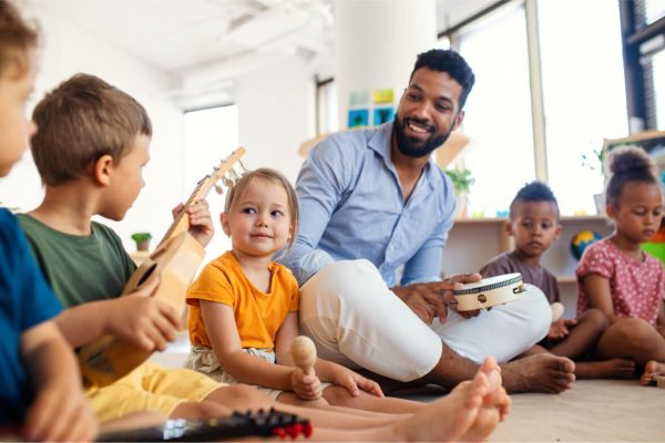nursery-school-children-with-man-teacher-sitting-o-2022-01-19-00-04-00-utc