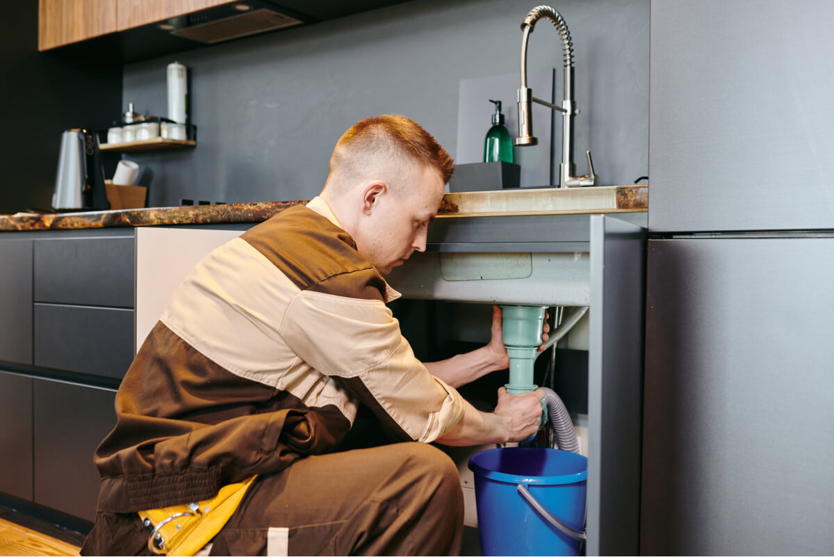 a-man-in-uniform-checking-plumbing-equipment-after-2021-09-24-03-42-54-utc
