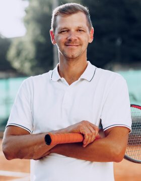 portrait-of-positive-male-tennis-player-with-racke-2021-09-03-13-00-10-utc